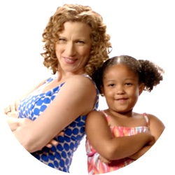Girl and Laurie Berkner standing back-to-back