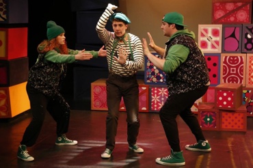 Three people performing a musical